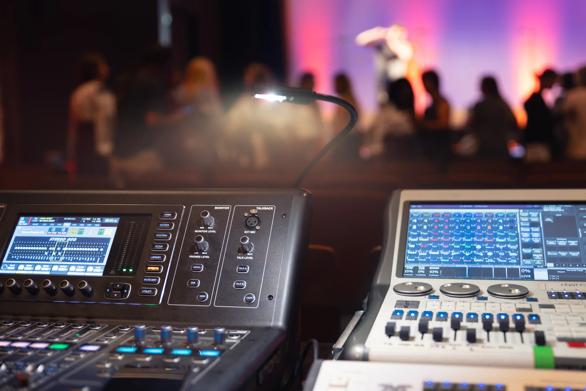 Professional sound and lighting control equipment at a live production