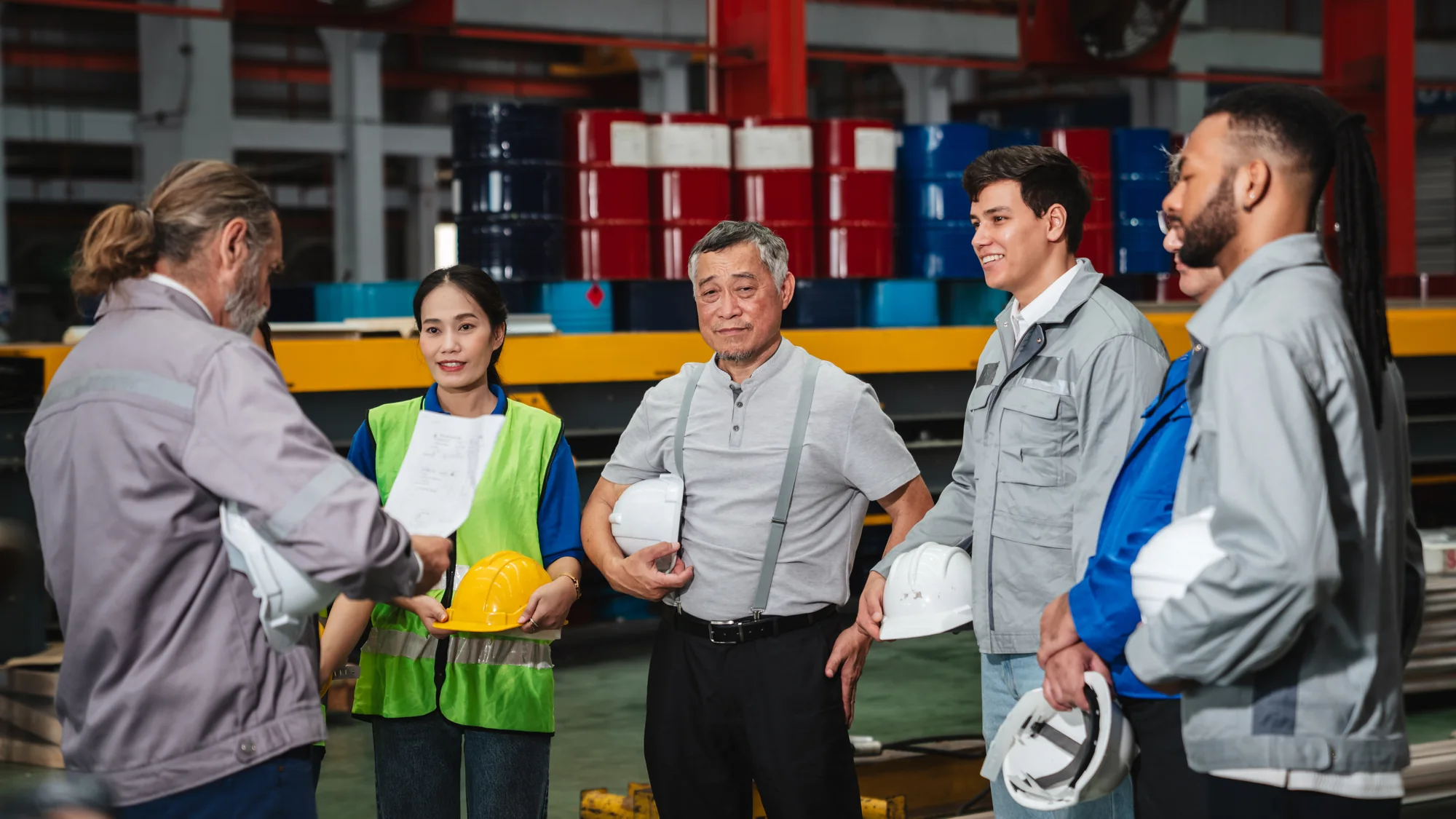 Industrial team discussing equipment and operations on a production floor