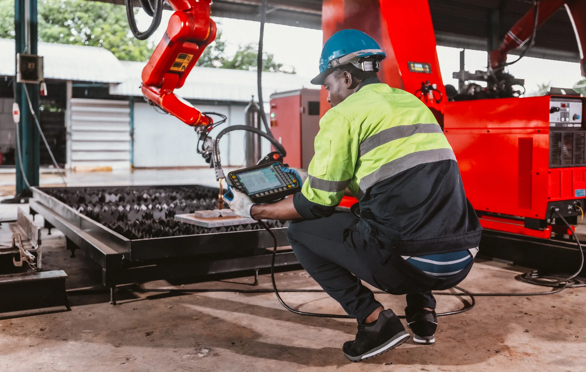Industrial operator working with automated machinery in a factory